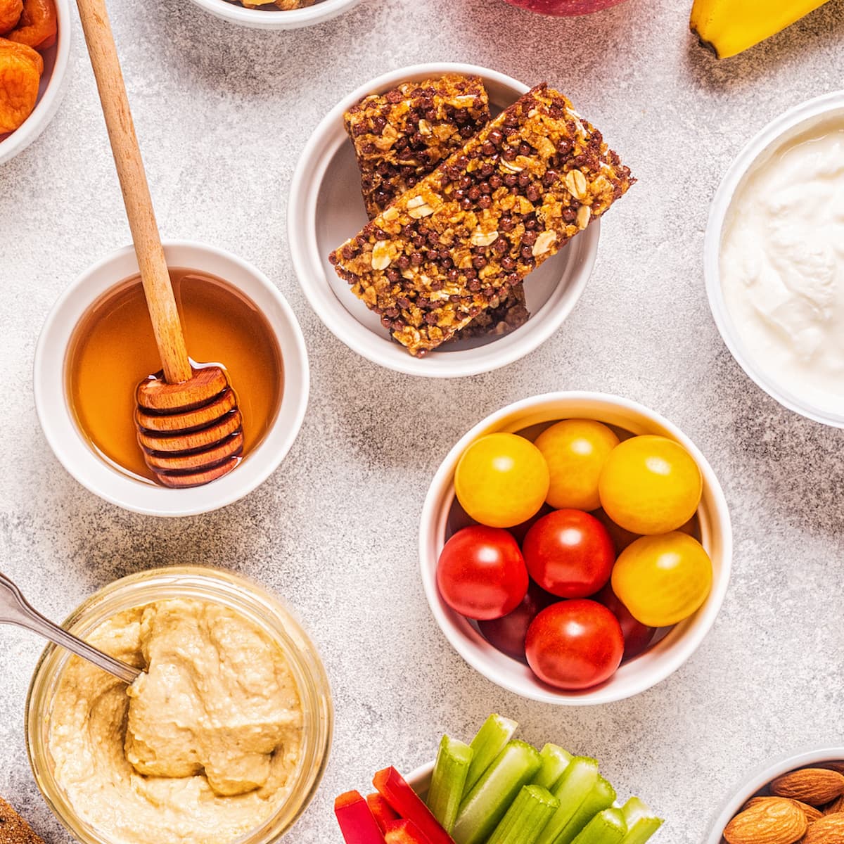 a square photo of a table with healthy food on it.