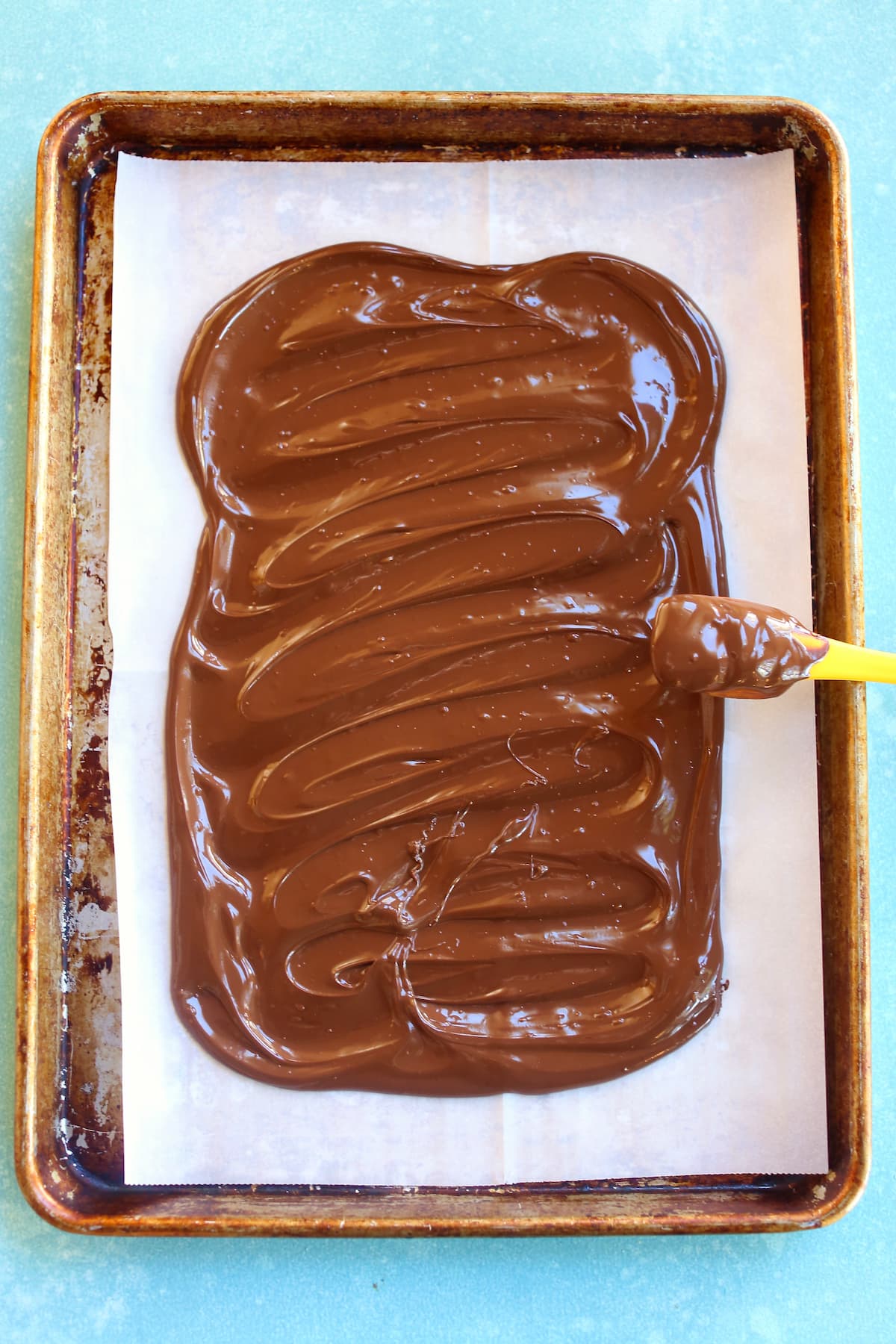 an overhead photo of dark chocolate on a baking sheet.