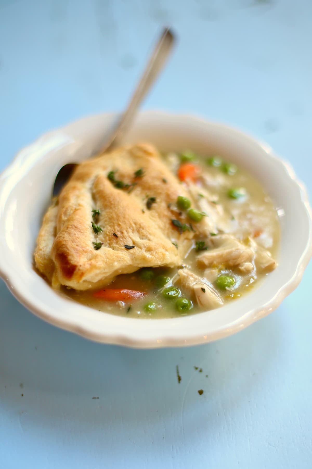 a side view of chicken pot pie with a spoon in it.