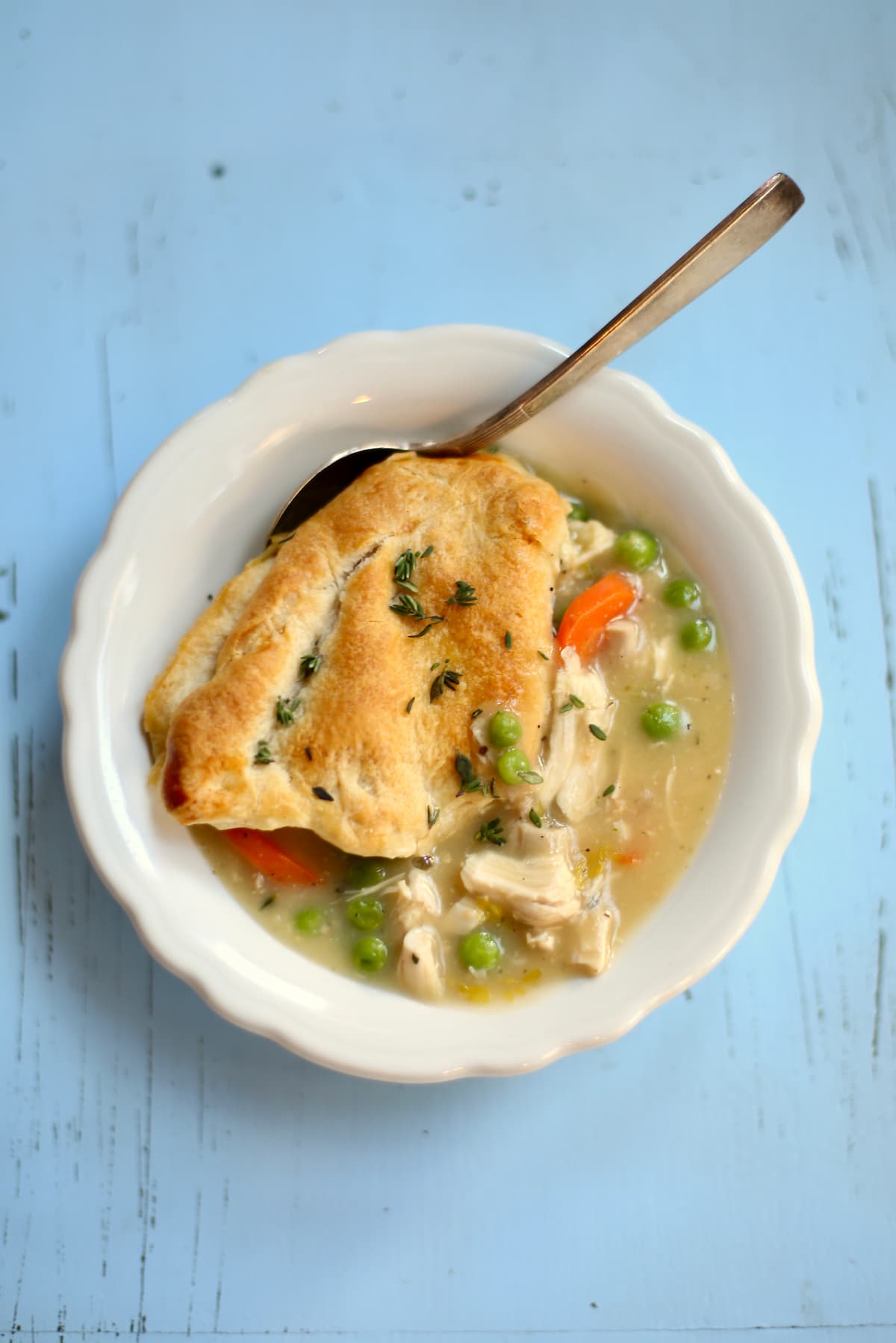 asmall overhead of chicken pot pie with a spoon coming out.