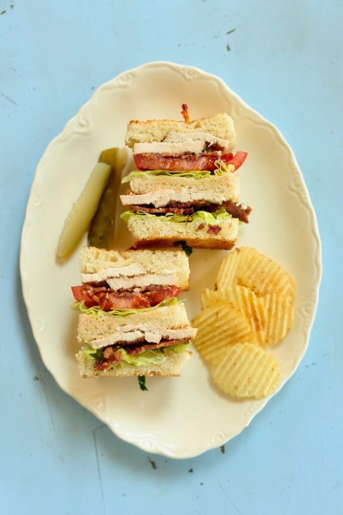 a clubhouse sandwich on a blue table.