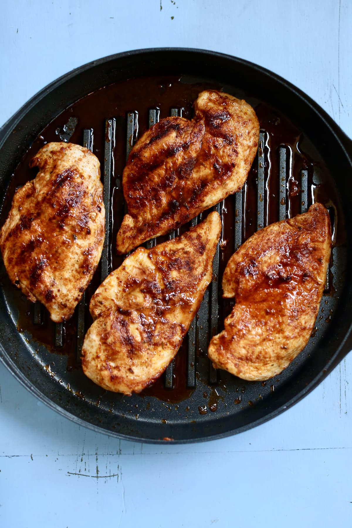 an overhead photo of grilled chicken in a skillet.