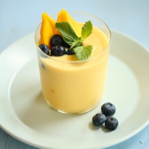 an overhead photo of a smoothie with blueberries as garnish.