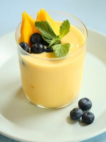 an overhead photo of a smoothie with blueberries as garnish.