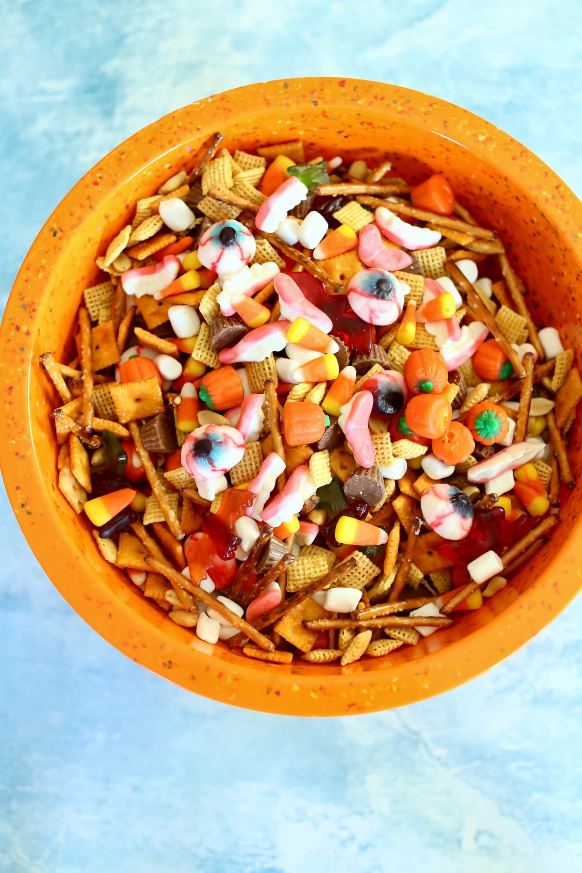 a large orange bowl of fall snack mix. 