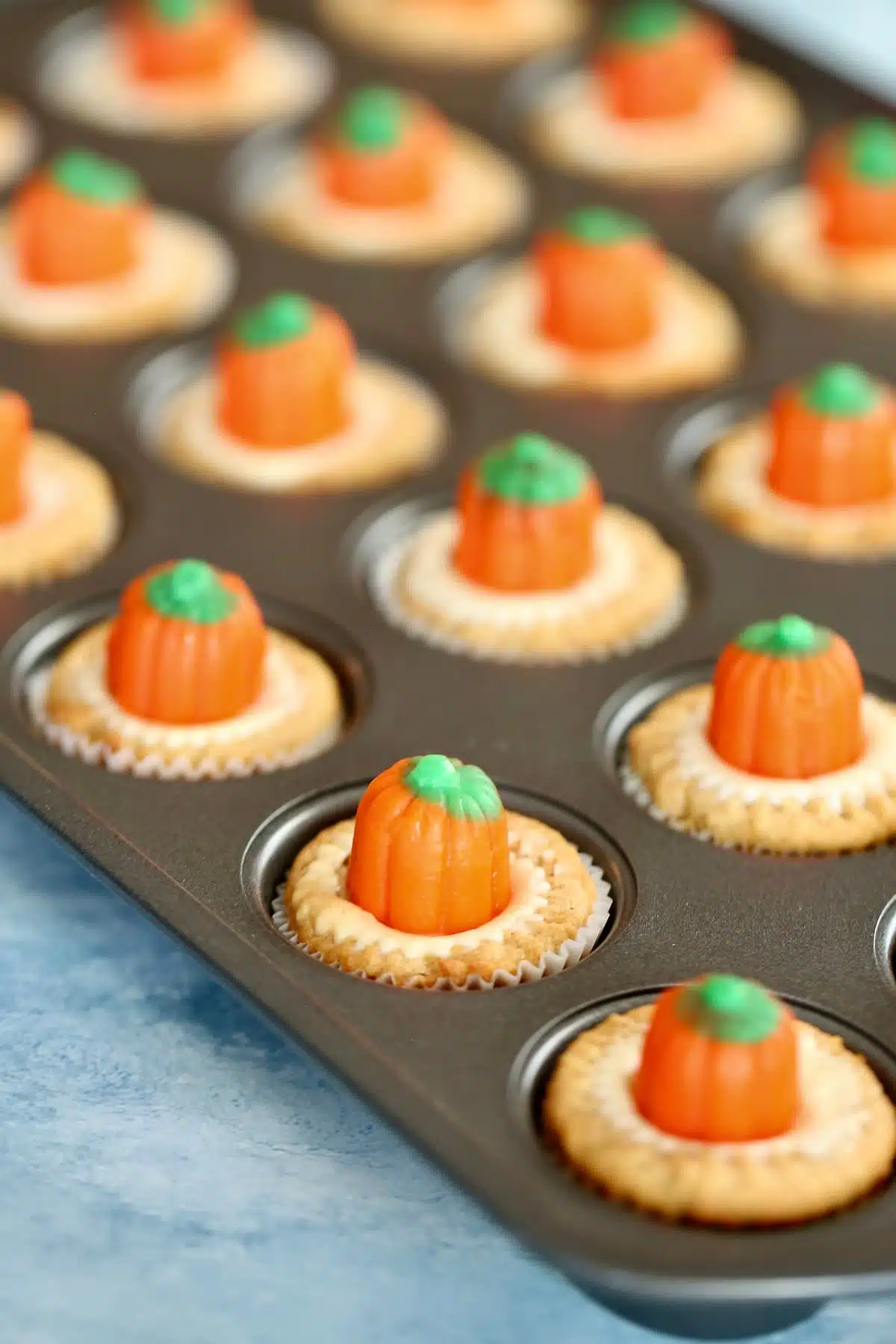 a mini cupcake baking tray filled with Halloween cupcakes.