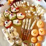 a Pinterest image of a tray of fruit halloween snacks.
