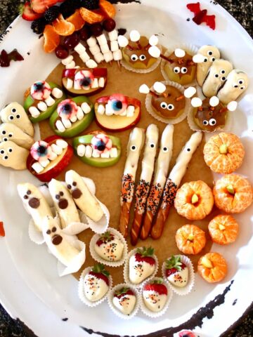 a square overhead image of fruit halloween snacks.