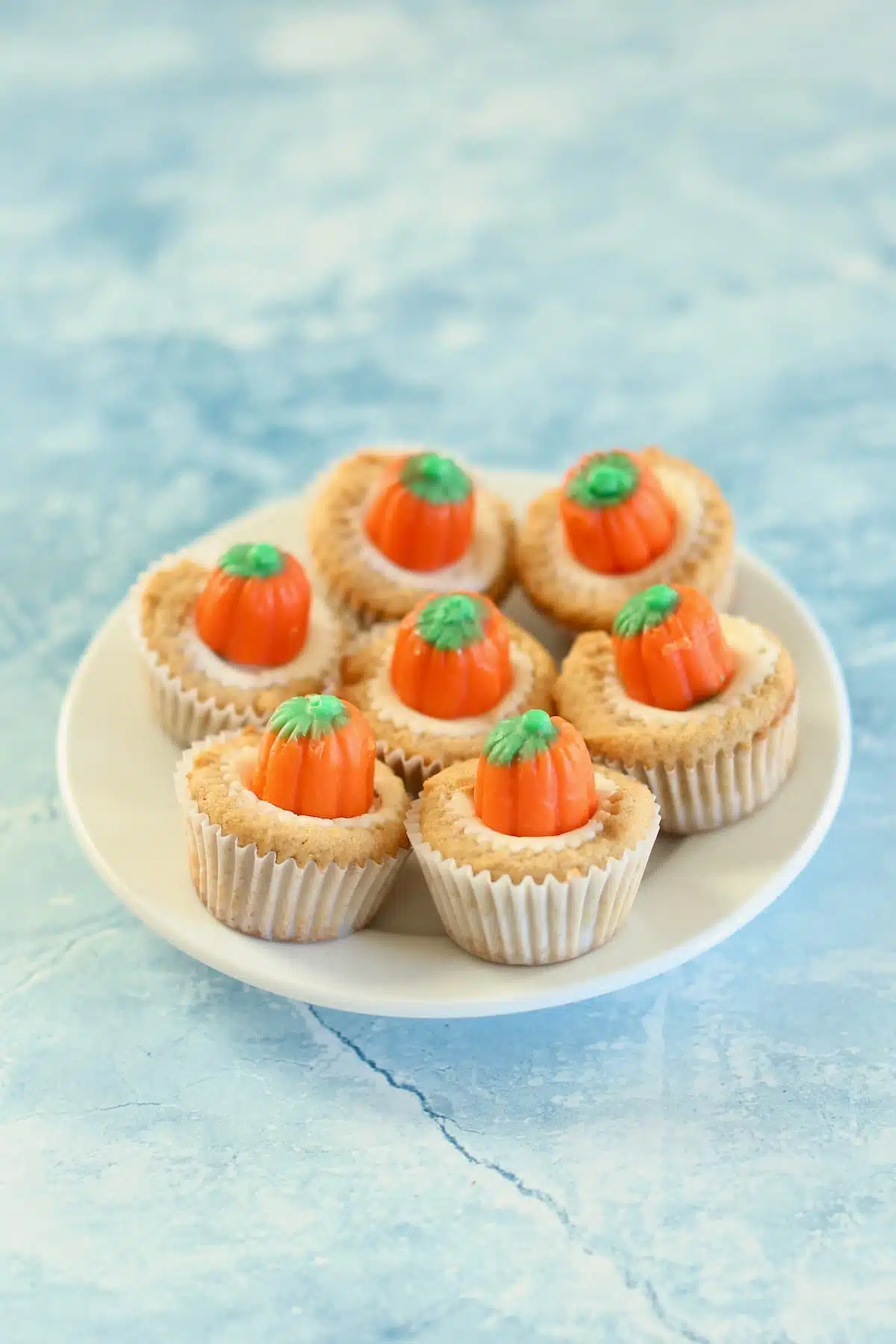 a small plate of mini Halloween cupcakes with a blue background.